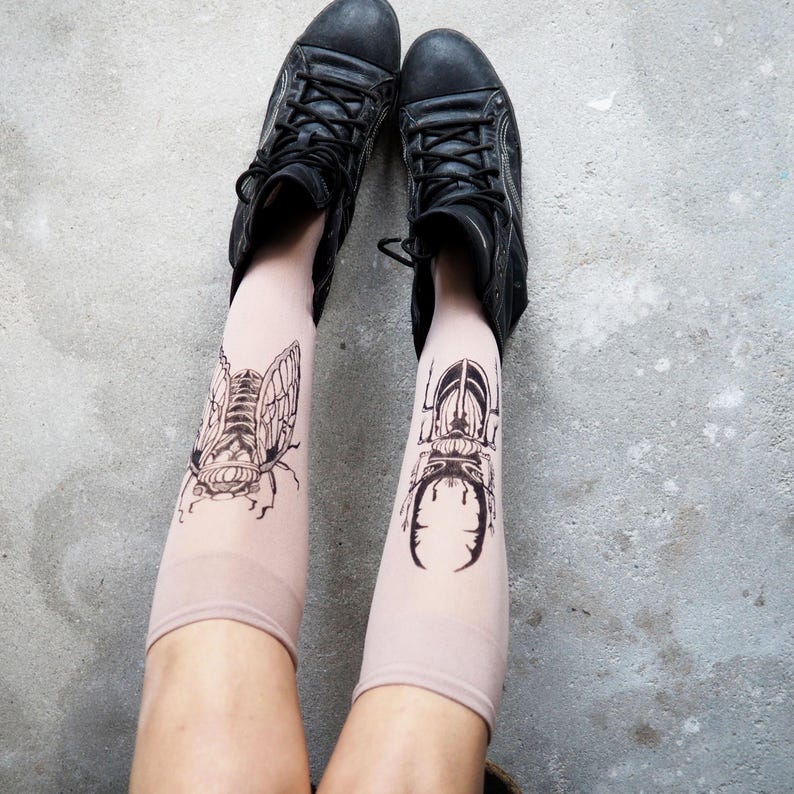 Hand-painted tattoo socks featuring intricate cicada and beetle artwork, perfect for entomology lovers, bug enthusiasts, and goblincore fashion. These unique, nature-inspired socks create a realistic tattoo illusion, combining art and style in wearable form. A thoughtful and quirky insect-themed gift for those who appreciate novelty and handcrafted designs.