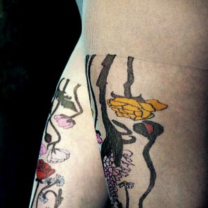 close up of colorful wildflower design on sheer tattoo tights