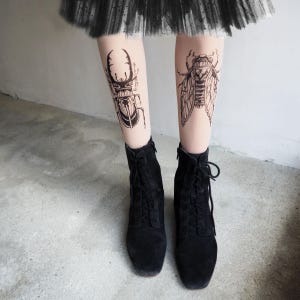 Hand-painted tattoo socks featuring intricate cicada and beetle artwork, perfect for entomology lovers, bug enthusiasts, and goblincore fashion. These unique, nature-inspired socks create a realistic tattoo illusion, combining art and style in wearable form. A thoughtful and quirky insect-themed gift for those who appreciate novelty and handcrafted designs.