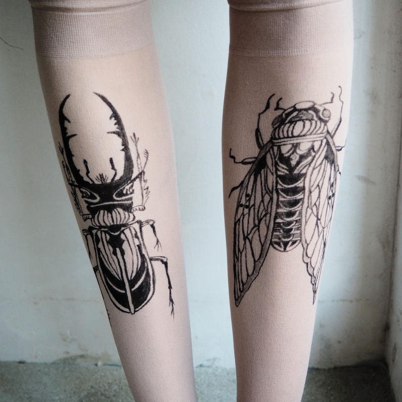 Hand-painted tattoo socks featuring intricate cicada and beetle artwork, perfect for entomology lovers, bug enthusiasts, and goblincore fashion. These unique, nature-inspired socks create a realistic tattoo illusion, combining art and style in wearable form. A thoughtful and quirky insect-themed gift for those who appreciate novelty and handcrafted designs.