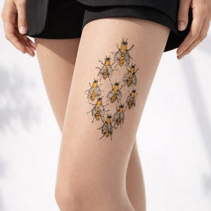 sheer nude tights with bee cluster print on thigh, detailed insect design for nature inspired outfits