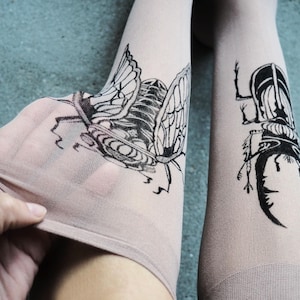 Hand-painted tattoo socks featuring intricate cicada and beetle artwork, perfect for entomology lovers, bug enthusiasts, and goblincore fashion. These unique, nature-inspired socks create a realistic tattoo illusion, combining art and style in wearable form. A thoughtful and quirky insect-themed gift for those who appreciate novelty and handcrafted designs.