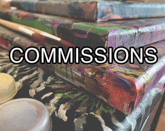 May include: A stack of colorful canvases with the word "COMMISSIONS" in white text on the front. The canvases are painted with abstract designs in various colors, including black, white, green, red, and purple.