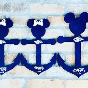 May include: Five blue wooden anchors with Mickey Mouse and Minnie Mouse heads. Each anchor has a white Disney Cruise Line logo and the name of a ship: "Fantasy", "Wonder", "Wonder", "Magic", and "Wonder". The years 2018 and 2019 are also included on the anchors.