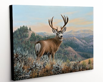 May include: A painting of a large, brown mule deer buck with a large rack of antlers standing on a grassy hillside. The deer is looking directly at the viewer. The background is a hazy blue sky with distant mountains.