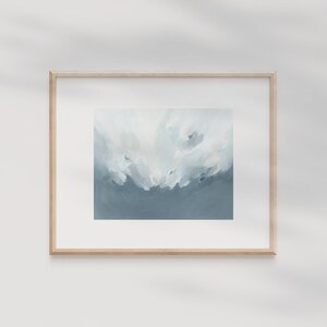 May include: A framed abstract painting with a light blue and white color scheme. The painting depicts a cloudy sky with a soft, ethereal feel.