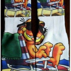 Pomarańczowe skarpetki dryfit z kotem