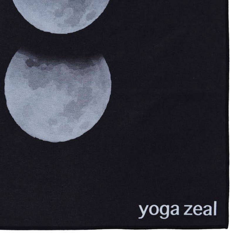May include: Black yoga mat with a white moon design and the text "yoga zeal" in white at the bottom.