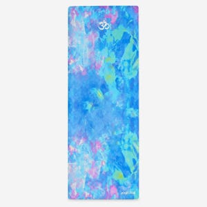 May include: A rectangular yoga mat featuring an abstract watercolor pattern in shades of blue, turquoise, and light pink. The surface displays a white Om symbol near the top center and the text "yoga zeal" printed in white at the bottom right corner.