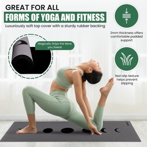 May include: A grey yoga mat with a black moon design and a woman demonstrating a yoga pose. The mat is 2 mm thick and has a non-slip texture. The text "Magically Grips the More you Sweat" is printed on the mat.