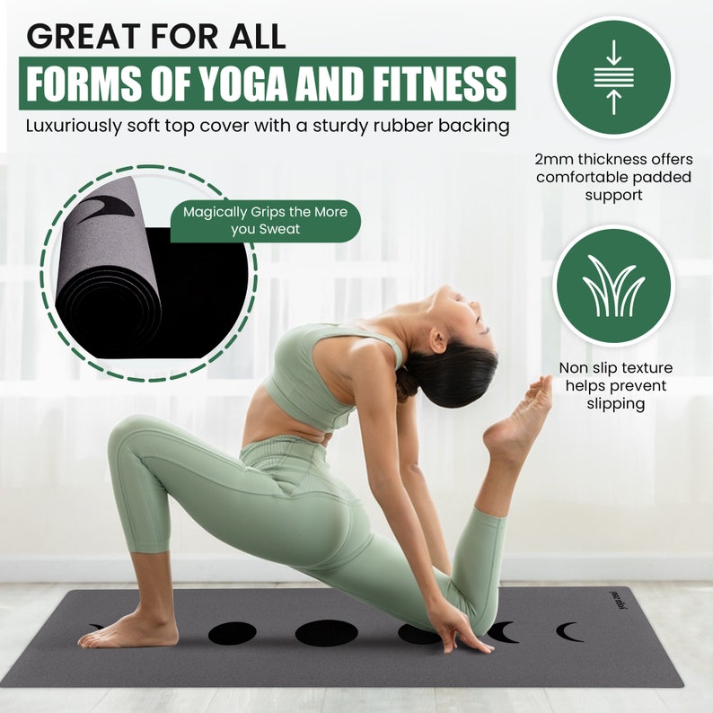 May include: A grey yoga mat with a black moon design and a woman demonstrating a yoga pose. The mat is 2 mm thick and has a non-slip texture. The text "Magically Grips the More you Sweat" is printed on the mat.