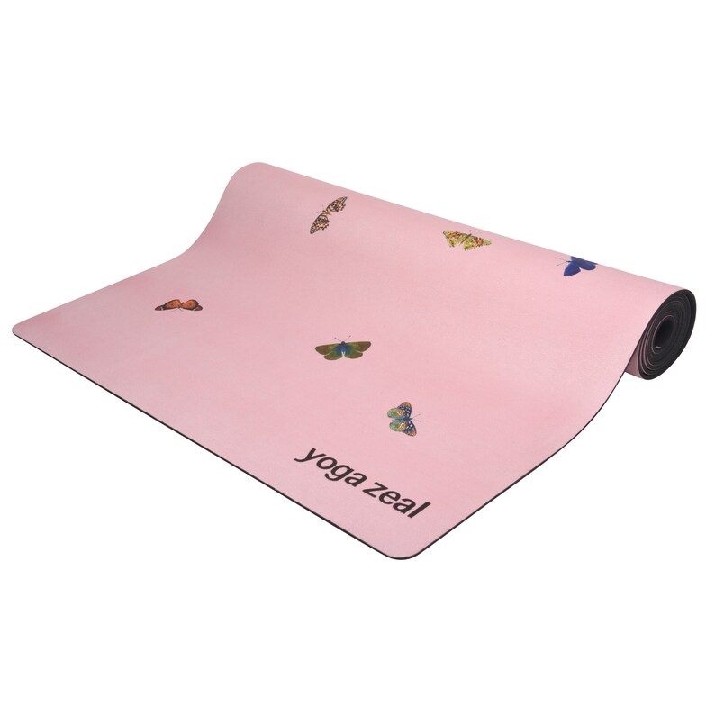 May include: A pink yoga mat with a butterfly design and the text "yoga zeal" printed on the bottom right corner.