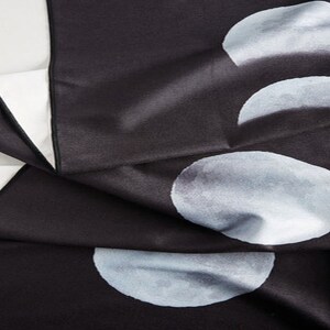 May include: Black tapestry with a white moon phase design. The tapestry features four different phases of the moon, each with a slightly different shade of white.