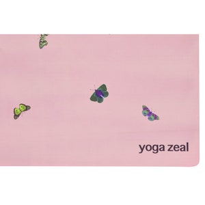 May include: Pink yoga mat with a butterfly pattern and the text "yoga zeal" printed on the bottom right corner.
