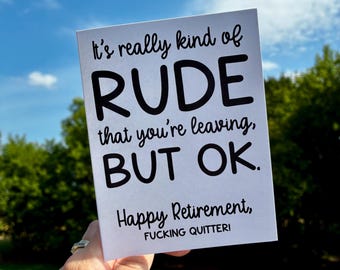 May include: A white greeting card with black text that reads "It's really kind of RUDE that you're leaving, BUT OK. Happy Retirement, FUCKING QUITTERI." The card is held up against a blue sky and green foliage.