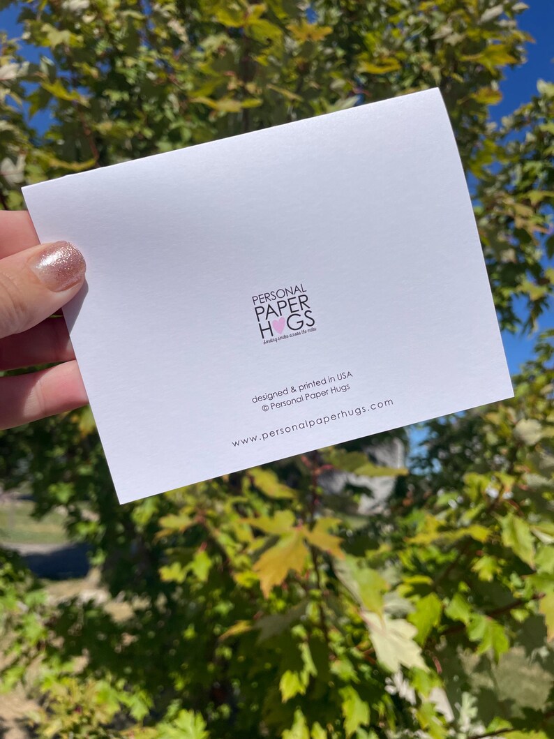 Może przedstawiać: Biała prostokątna kartka okolicznościowa z czarnym napisem PERSONAL PAPER HUGS i r&oacute;żową ikoną serca, po kt&oacute;rej następuje tekst designed & printed in USA &copy; Personal Paper Hugs oraz adres strony internetowej www.personalpaperhugs.com.