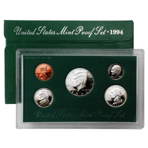 May include: A green and clear plastic case containing a 1994 United States Mint Proof Set. The set includes a penny, nickel, dime, quarter, and half-dollar.
