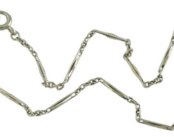 May include: A silver pocket watch chain with a T-bar clasp. The chain is made of alternating links, some of which are plain and some of which are decorated with a diamond pattern.