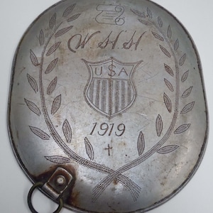 World War I Trench Art dated 1919 centered with initials W.H.H USA Shield with Scroll, Laurel Leaves a Cross WWI Great War Aluminum Pot Lid