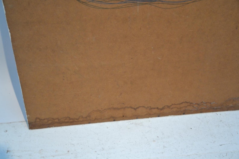 May include: A section of brown paper with a white edge. The paper has a textured surface and some dark brown stains along the bottom edge. Faint blue lines are visible at the top.
