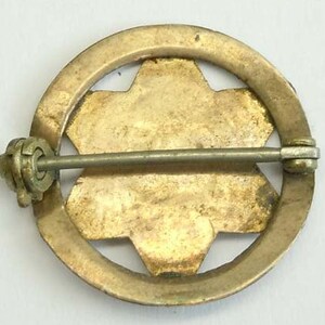 K&ouml;nnte beinhalten: Goldfarbener Metallstift mit einem sechszackigen Sternmuster. Der Stift hat einen Sicherheitsverschluss auf der R&uuml;ckseite.