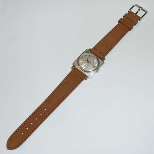 May include: A silver square-shaped wristwatch with a white face and black hands. The watch has a brown leather band with a buckle closure.