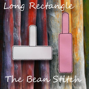 May include: Two rectangular tags with a handle, one white and one pink, both outlined in black stitching. The text "Long Rectangle" is at the top, and "The Bean Stitch" is at the bottom.