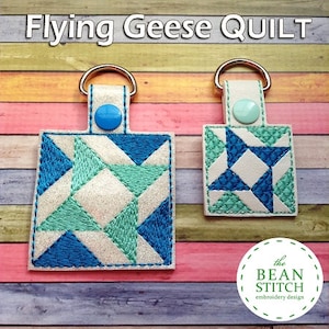 May include: Two white fabric keychains with blue and green embroidered flying geese quilt blocks. The keychains are attached to silver key rings. The text "the BEAN STITCH embroidery design" is on a white circle with a green border.