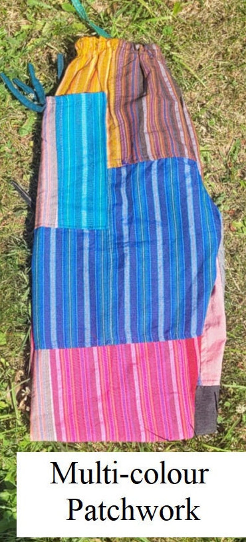 May include: Multi-colored patchwork pants with a striped pattern. The pants are made of different fabrics and colors, including blue, pink, yellow, and brown.