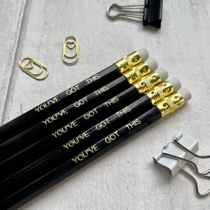 May include: Five black pencils with gold lettering that reads "You've Got This".