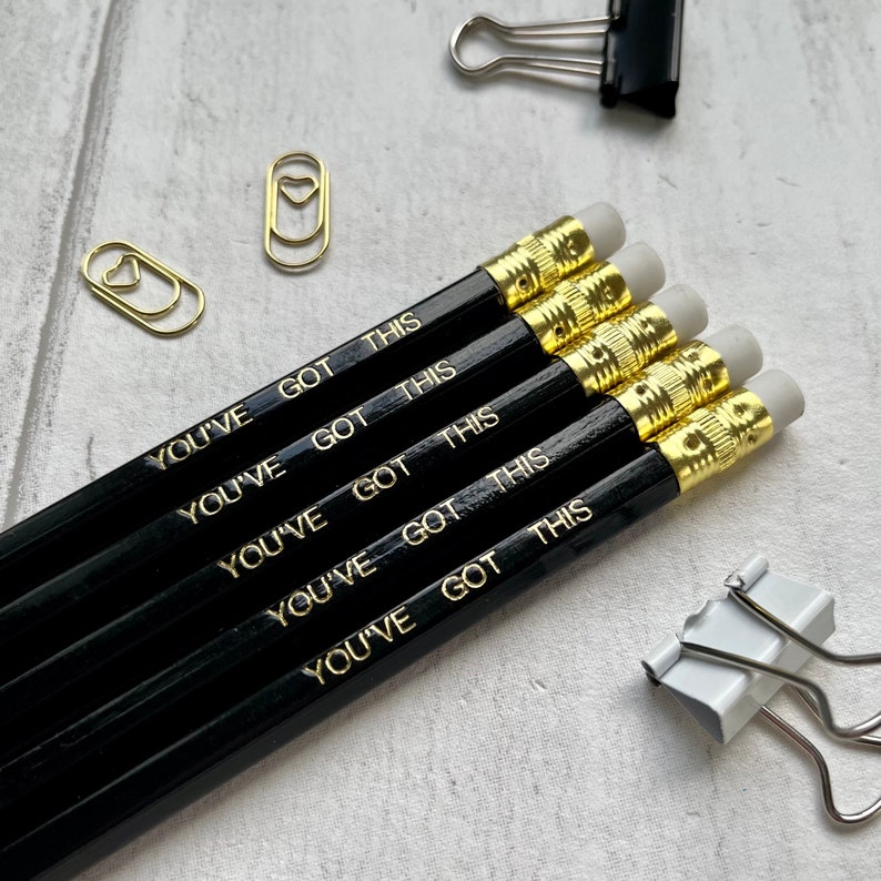 May include: Five black pencils with gold lettering that reads "You've Got This".