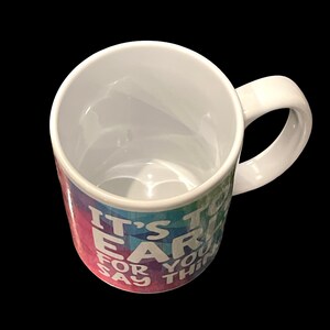 May include: White ceramic mug with a rainbow ombre design and the text "It's too early for you to say that".