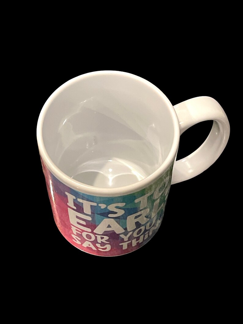 May include: White ceramic mug with a rainbow ombre design and the text "It's too early for you to say that".