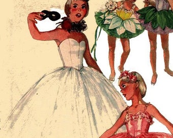 May include: Three girls wearing different ballerina costumes. The girl in the center is wearing a white tutu and holding a pair of black maracas. The girl on the left is wearing a green and yellow flower-shaped tutu. The girl on the right is wearing a pink tutu.