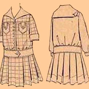 May include: A beige plaid dress with a button-up front and a matching jacket. The dress has a skirt with pleats and the jacket has long sleeves.