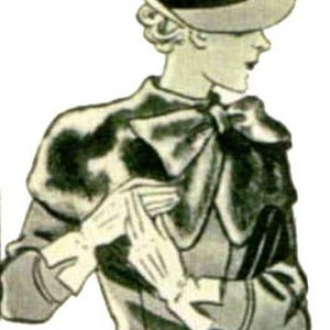 Puede incluir: Una mujer con un sombrero gris con una banda negra y un abrigo negro y gris con un gran lazo en el cuello. Lleva guantes blancos.