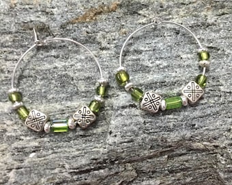 Beaded gold and green metal hoop earrings with celtic metal bead accents
