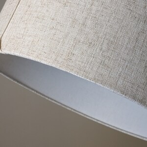 close up of bottom edge of handmade lamp shade in Calacatta Gold Flax fabric