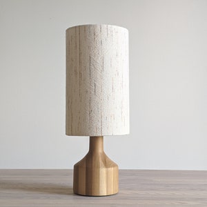 a light wood lamp has a Confetti fabric lamp shade with the fabric running vertically to show what this looks like