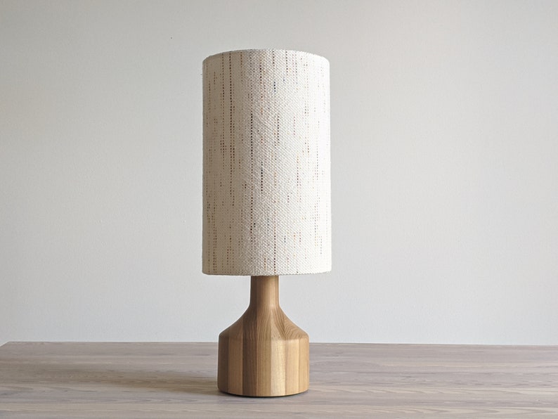 a light wood lamp has a Confetti fabric lamp shade with the fabric running vertically to show what this looks like