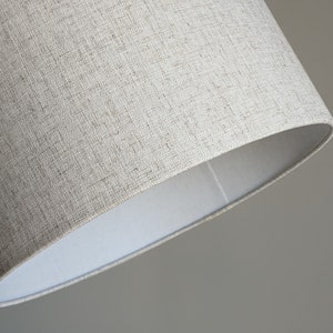 close up of bottom edge of handmade lamp shade in Calacatta Gold Flax fabric