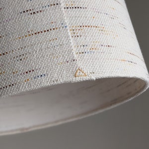 close up image of lamp shade seam with a yellow triangle stitch detail