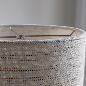 close up image of top edge of Handwoven Confetti Fabric Lamp Shade with nickel finish hardware