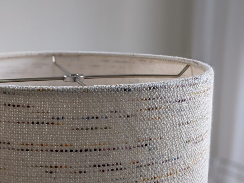 close up image of top edge of Handwoven Confetti Fabric Lamp Shade with nickel finish hardware