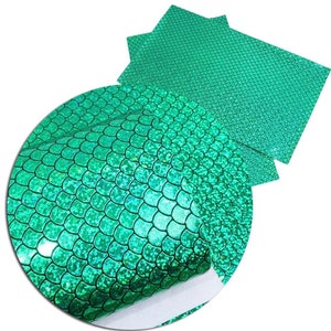 May include: Green iridescent mermaid scale faux leather fabric. The fabric has a holographic finish and is perfect for crafting projects.