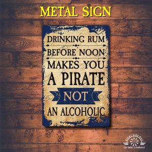 May include: A blue and brown metal sign with the text "Drinking rum before noon makes you a pirate not an alcoholic".