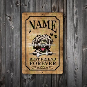 Puede incluir: Un letrero metálico rectangular con un fondo de aspecto de madera envejecida. El letrero presenta una ilustración de un perro sosteniendo un hueso, huellas de patas y las palabras "NAME" y "BEST FRIEND FOREVER" en letras negras.