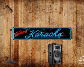 May include: A black karaoke speaker and microphone stand are positioned in front of a wooden background. A neon sign that reads "Steve's Karaoke" in red and blue is also present. The image is a promotional shot for a karaoke business.