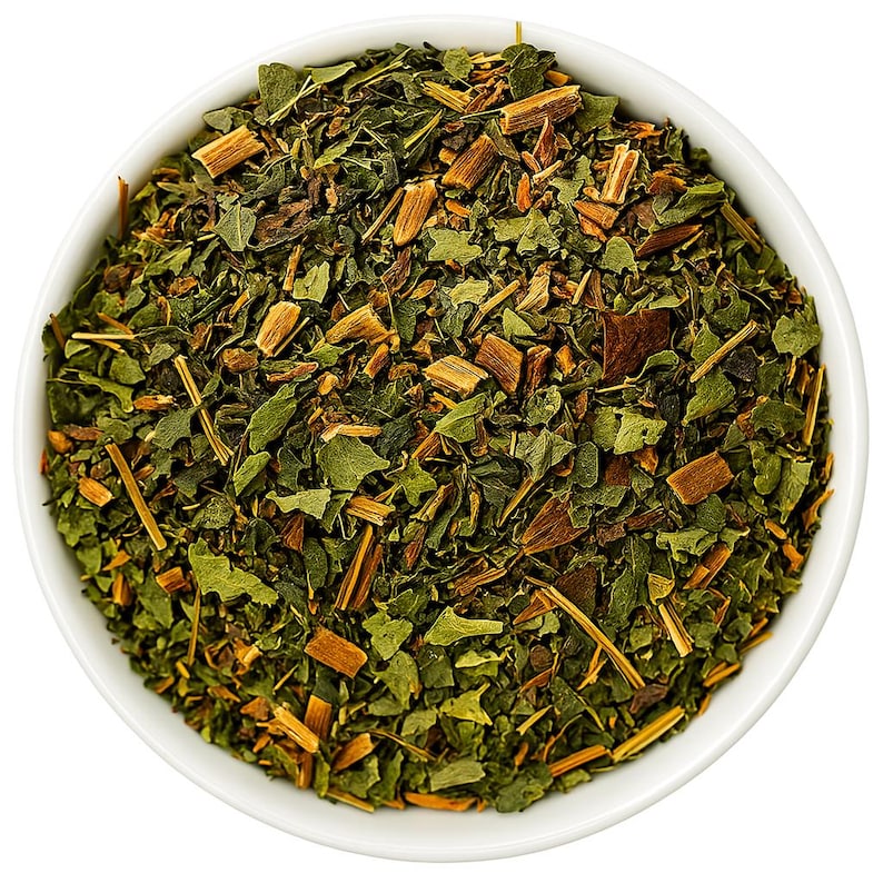 May include: A white bowl filled with a blend of loose leaf green tea and dried herbs.