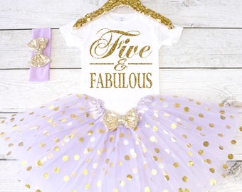May include: A purple tulle tutu with gold polka dots, a white onesie with gold glitter text that says "Five & Fabulous", and a purple headband with a gold glitter bow.